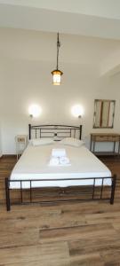 a bedroom with a large bed with white sheets at Amoraninew in Batsi