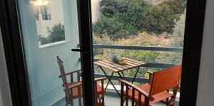 a table and chairs on a balcony with a view at Amoraninew in Batsi