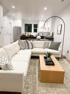 a living room with a white couch and a table at 110 Downtown in Provo