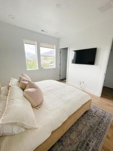 a bedroom with a large bed and a flat screen tv at 110 Downtown in Provo