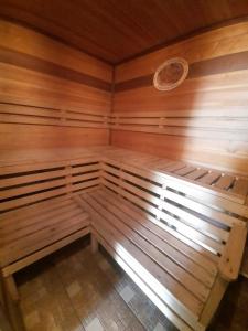 a small sauna with wooden walls and a window at House Baikal in Baykalsk
