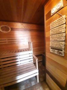 a sauna with a bench in a wooden wall at House Baikal in Baykalsk