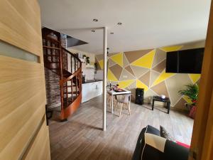 a living room with a staircase and a kitchen at L évasion secrète in Quarouble