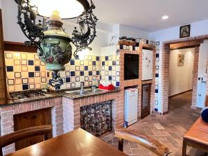 a kitchen with a table and a sink and a stove at Duprè Apartment in Siena