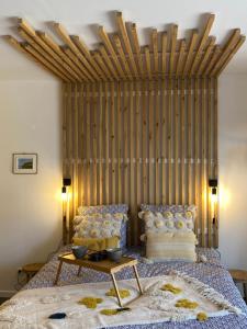 een slaapkamer met een groot bed met een houten hoofdeinde bij Studio Beach House à Sangatte bord de plage in Sangatte