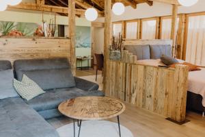 a living room with a couch and a bed at Exklusives Loft "Auszeit für2" in Lofer