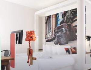 a room with a dog wearing glasses on a wall at The Corner London City in London