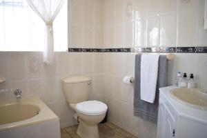 a bathroom with a toilet and a sink at Secure Private Flatlet in Newton Park in Port Elizabeth +8 photos