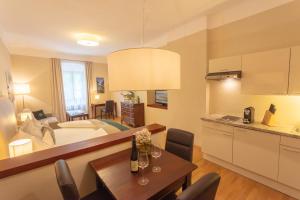 a kitchen and a living room with a dining room at Donauwirt - Hotel garni in Weissenkirchen in der Wachau