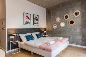 a bedroom with a large white bed with blue pillows at Piedmont House in Krakow