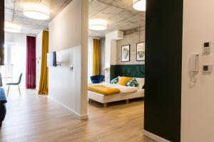 a bedroom with a bed and a room with a table at Piedmont House in Krakow +93 photos