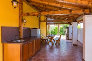 a kitchen with yellow walls and a wooden ceiling at Villa Nada in Buje