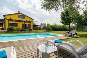 a backyard with a pool and a house at Villa Nada in Buje