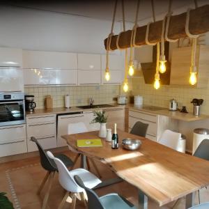 a kitchen with a wooden table and chairs at Ferienwohnung Zollverein in Essen