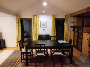 a dining room with a black table and chairs at Haus Luzia in Reith im Alpbachtal