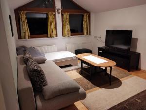 a living room with a couch and a table at Haus Luzia in Reith im Alpbachtal