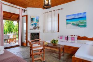 a living room with a bed and a table at Giola Bungalows Sirines in Astris