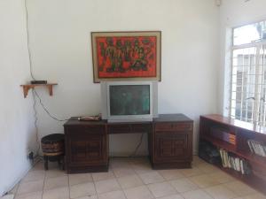 a television sitting on a desk in a room at Fourways Johannesburg Hostel in Johannesburg