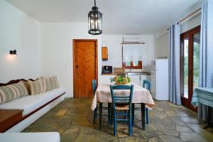 a kitchen and dining room with a table and chairs at Giola Bungalows Sirines in Astris +43 photos