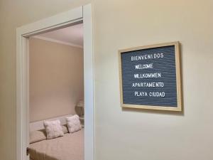 a mirror in a bedroom with a sign on the wall at Apartamento Playa Ciudad in Santa Cruz de la Palma