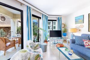 a living room with a blue couch and a tv at Ca Na Bel in Port de Soller