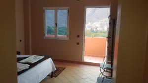 a bedroom with a bed and a large window at Auberge Restaurant Fatihi Freres in Tinerhir +30 photos
