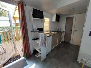 a kitchen with a sink and a counter top at Mobil home climatisé Carnac in Carnac