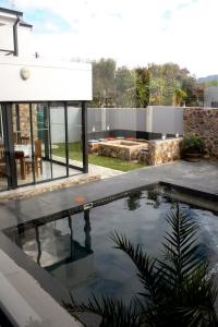 a swimming pool in the backyard of a house at Elizabeth House in Hermanus