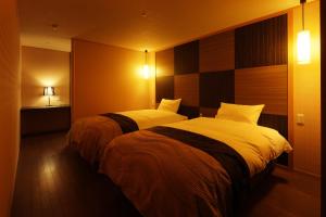 Voodi või voodid majutusasutuse Kintarou Onsen Hotel toas