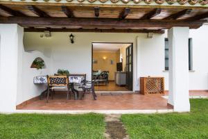 a patio with a table and chairs on it at Villa Iris with Pool in Baja Sardinia