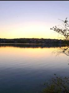 a view of a lake with the sun setting at Ferienwohnung mit Terrasse für bis zu 4 Personen in Balve