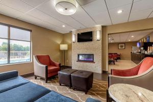 a lobby with a waiting room with chairs and a tv at Comfort Inn & Suites Mocksville I-40 in Mocksville
