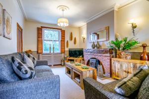 a living room with two couches and a fireplace at River View, Stamford Bridge in Stamford Bridge