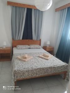 a bedroom with a bed with two towels on it at Makenzy 12 in Larnaka