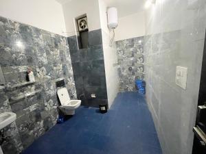 a bathroom with a toilet and a sink at Malsi Hill View Homestays in Dehradun +15 photos