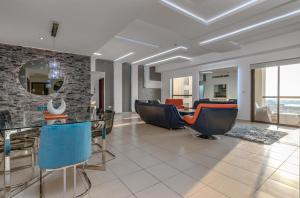 a living room with a table and chairs at Elan Rimal 5 Suites in Dubai