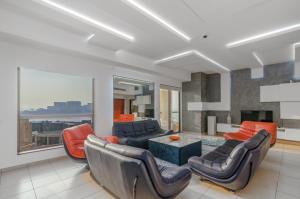 a living room with a couch and chairs and a table at Elan Rimal 5 Suites in Dubai