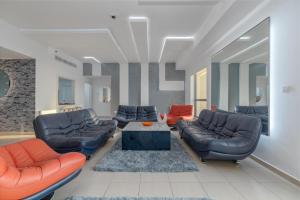 a living room with couches and a coffee table at Elan Rimal 5 Suites in Dubai