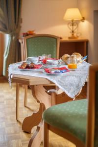 a table with a plate of food on it at Hotel Piccolo Pocol in Cortina dʼAmpezzo