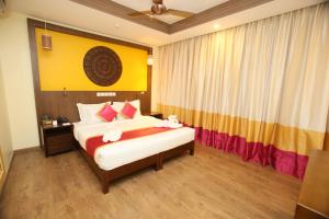 a bedroom with a bed with flowers on it at Vivin Luxury Suites in Trivandrum