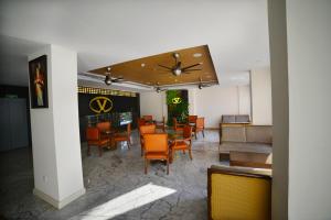 a dining room with a table and chairs at Vivin Luxury Suites in Trivandrum