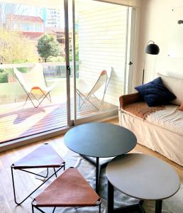 a living room with a couch and a table at Stylish Apartment by River with Pool & Grill in Olivos +20 photos