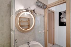 a bathroom with a sink and a mirror on the wall at Casa via Montà in centro in Sanremo +20 photos
