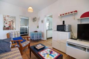 a living room with a couch and a tv at Beautiful Traditional House in Chipiona