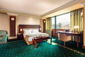 A bed or beds in a room at Grand Hotel Sofia