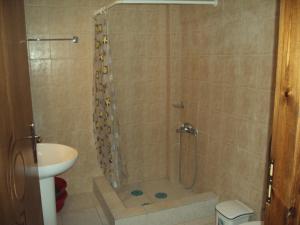 a bathroom with a shower with a toilet and a sink at Marietta's Apartments in Agios Andreas +88 photos