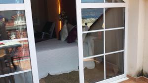 a bedroom with a bed and a window at Hotel Viento del Norte in Porto de Espasante
