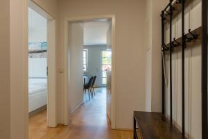 a hallway with a room with a bed and a table at Mädesüß 02 in Ahrenshoop