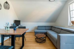 a living room with a couch and a table at Mädesüß 02 in Ahrenshoop