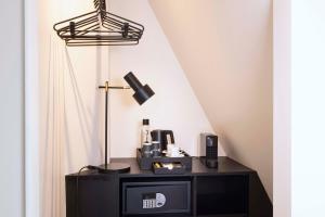 a black desk with a lamp on top of it at Le 12 Hôtel in Paris